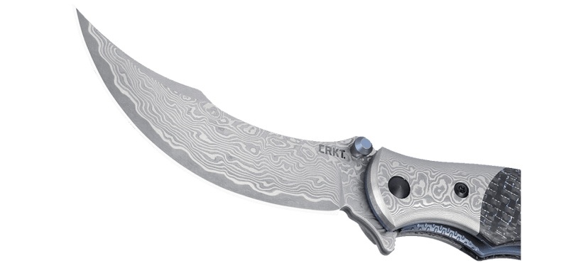 CRKT 7466 Ritual™ Compact to inspirowany perskimi ostrzami, ekskluzywny nóż składany.Mimo niewielkich rozmiarów robi oszałamiające wrażenie, dzięki wykonaniu ze stali damasceńskiej i charakterystycznemu wykończeniu oraz akcentom z anodyzowanego na niebiesko tytanu.Nowoczesności i funkcjonalności dodają mu blokada ostrza Liner Lock, system łożysk IKBS oraz stalowy, sprężysty klips, kolorystycznie nawiązujący do całości.Nóż sprzedawany jest w komplecie z eleganckim - LifeGun.pl NÓŻ CRKT 7466 RITUAL COMPACT CARBON-3